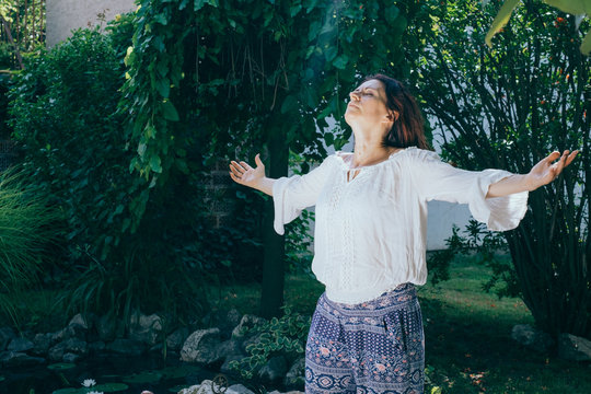 Woman doing yoga in her backyard