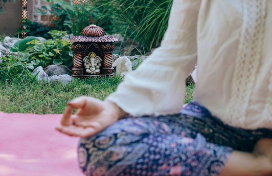 Anonymous Woman Meditating in her backyard