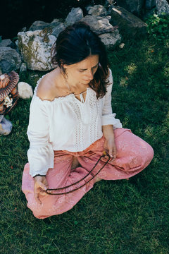 Woman Chanting mantras in her backyard