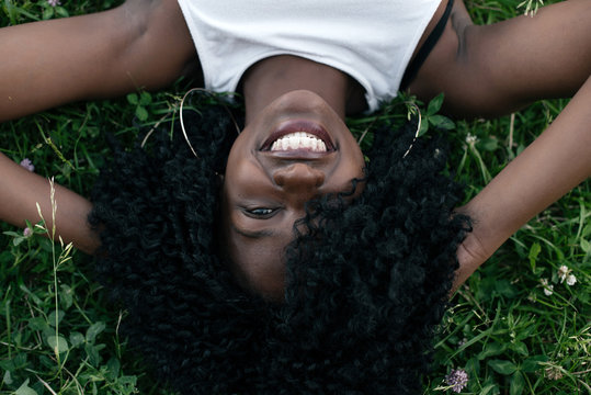 Portrait of gorgeous african girl laying on the grass