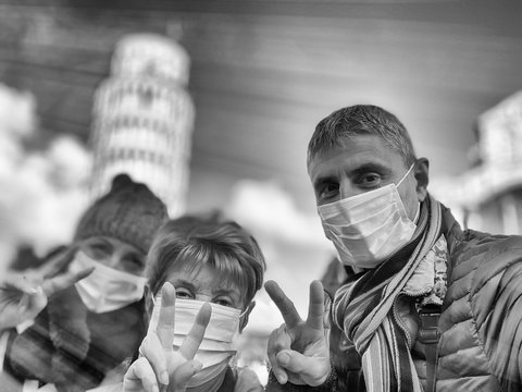 Man with his mother and wife wearing masks visiting italian landmark in coronavirus times