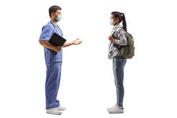 Male doctor with medical mask talking to a female student