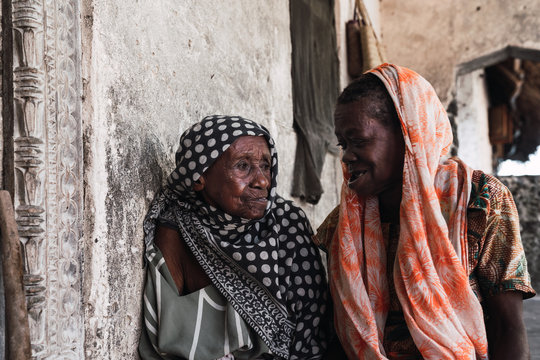 Mother and daughter. Two old african woman wearing a headscarf.