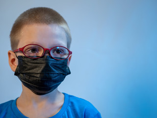 Two boys in dirty medical masks are quarantined at home. Children cough hard and get dirty with masks quickly. concept of fight against coronavirus epidemic and proper prevention of infections