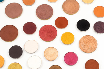 Round multicolored make up eyeshadows isolated on white.