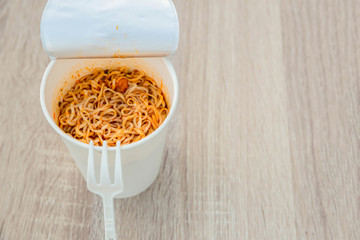 Hot noodle Cup. Noodle cup Ready made. Eating Instant Noodles with a Plastic Fork. Junk food Instant noodles are eating the popular food.