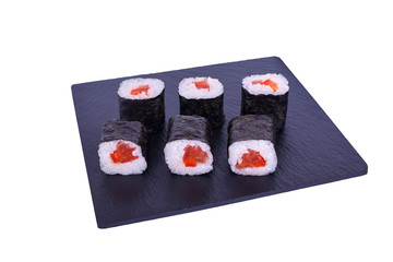Traditional fresh japanese sushi maki on black stone Maki Yasai on a white background. Roll ingredients: tomato, bell pepper, nori, rice.