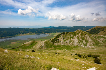 Matese lake and Valle dell'Esule surrounded by green grass in springtime. Matese Park, Campania, Italy