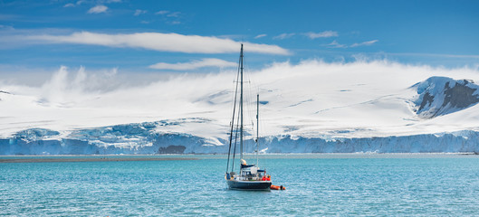 panoramic view to yacht into harbour in Antarctica © sergejson