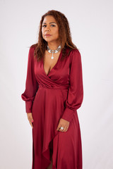 Thoughtful Hispanic woman in a red dress