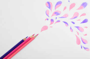 Abstract drawing and colorful pencils on white background, top view