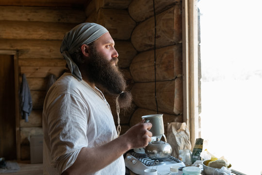 Bearded man with mug of tea