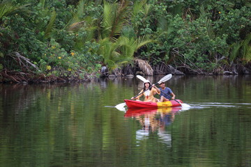 Men and women are kayaking in the canal