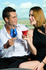 Beautiful couple having a cocktail or a drink in a bar
