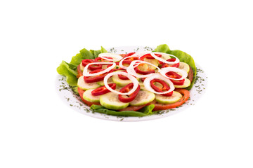 Vegetables sliced in rings: tomatoes, cucumbers, red peppers and white onions. Served on a white plate, melted on a white background. Photo suitable for feeding may restaurant. Dish of Montenegrin cui