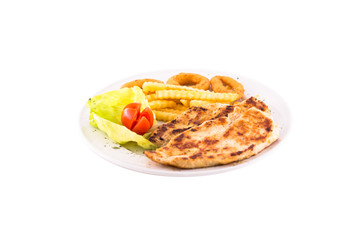 Grilled chicken breast with french fries, tomato and a leaf of green salad. Photo taken on a white background. Dish of Balkan cuisine. Suitable for restaurant menu.