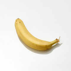 Yellow ripe banana lies on a white background