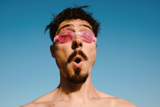 Man in swimming goggles summer vibrant portrait