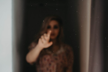 Shadowed women sitting in an empty room