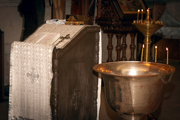 font with three candles for the sacrament of Epiphany. Orthodox Church.