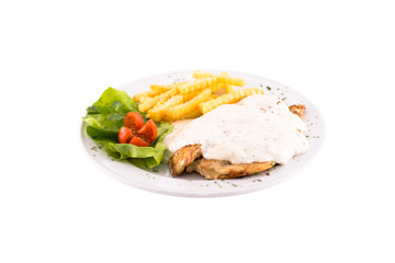 Grilled chicken fillet with cream sauce with mushrooms and french fries. Served on a white plate, melted on a white background. Photo suitable for feeding may restaurant. Dish of Montenegrin cuisine.