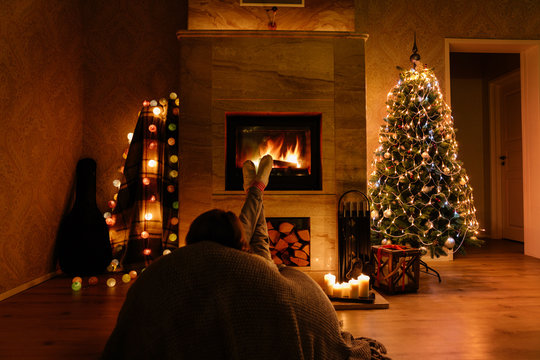 Woman at the Christmas fireplace