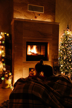 Anonymous couple by the fireplace