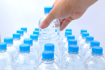 Hand hold one bottle of Pack of Plastic bottle isolated on white background, Top view