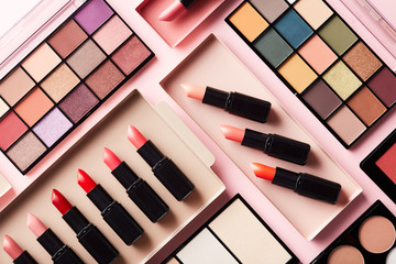 Layout of colorful eye shadow palettes and lipsticks
