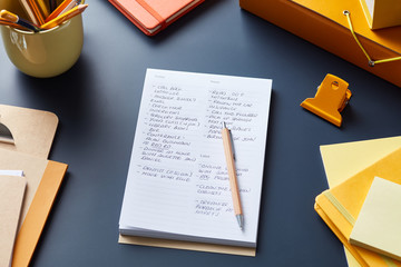 Desk with notepad and colorful supplies