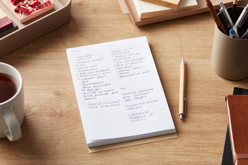Handwritten notes in pad on wooden desk