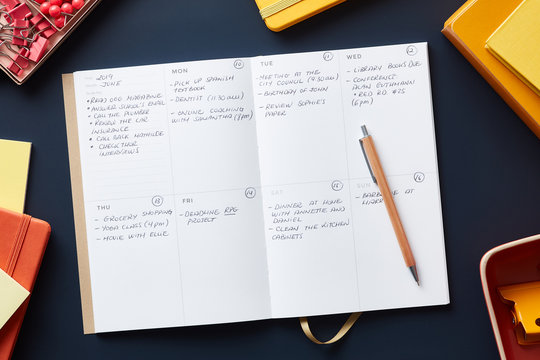 Planner with notes on blue desk