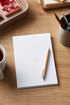 Empty notebook with tea mug on desk
