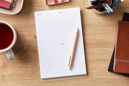 Office supplies with notepad and tea cup