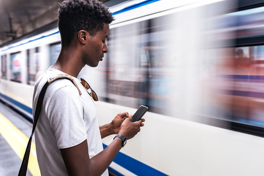 Young Man Standing On Metro Station Platform