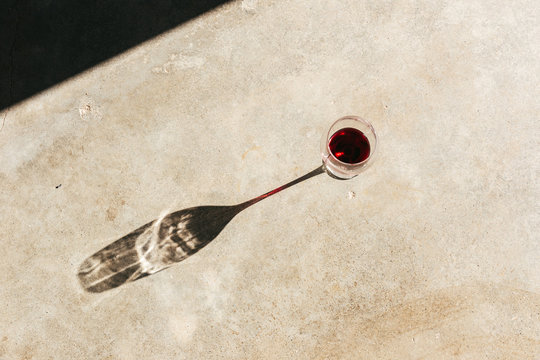 Single glass of red wine in sunlight