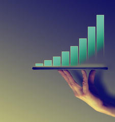 Hand Holding A Tablet With A Economic Block Projection