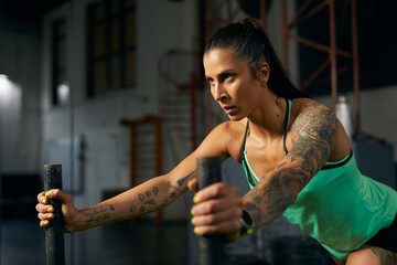 Sportswoman pushing weights.