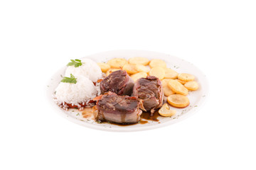 Ham meat medallions. Boiled rice and fried potatoes are served on the side dish. Photo taken on a white background. Dish of Montenegrin cuisine. Suitable for the restaurant menu.