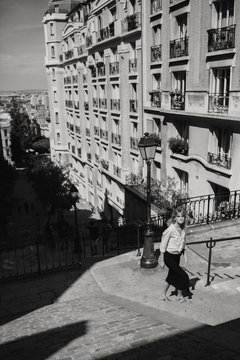 A portrait of a young girl standing on the spotlight on the streets of Paris