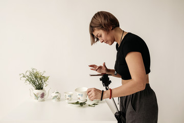 Woman take photos with porcelain via smartphone