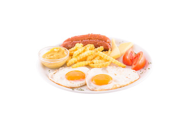 Grilled sausages with two eggs, tomatoes and french fries. Photo taken on a white background. Dish of Montenegrin cuisine. Suitable for the restaurant menu.