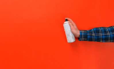 a hand with a spray paint can isolated on a colorful background mockup