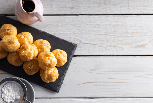Delicious profiteroles, cream puff filled with fresh cream with chocolate topping.