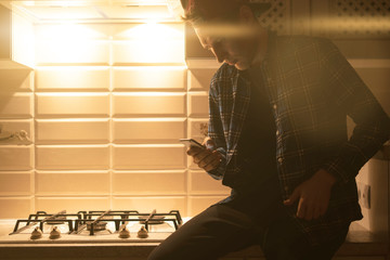 Fototapeta premium the night social media addiction concept, male person using the digital device and chat with friends online at home
