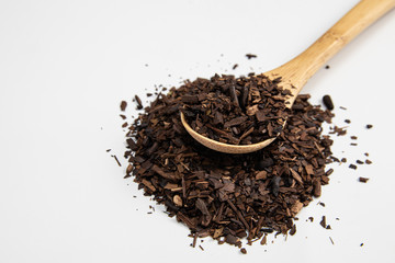 Toasted Erva-Mate into a measuring spoon.