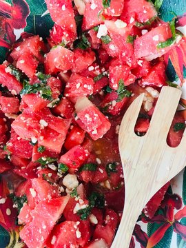 Watermelon basil salad with serving spoon