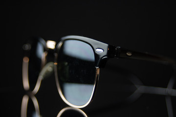 clubmaster sunglasses on black mirror background 