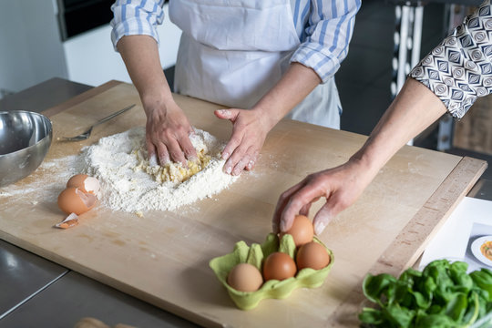 Women preparing food in a kitchen class - Powered by Adobe