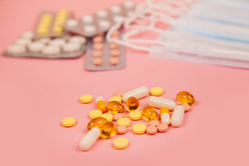 Glass of water, medication pills in blister pack and mask. Means, treatment for viruses. Pink...